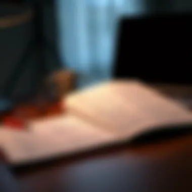 An open book with notes and a laptop on a desk